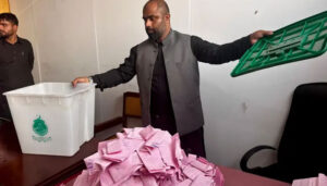 A man holds a green box filled with pink papers, showcasing a colorful and organized display. A man displays a green box containing pink papers, emphasizing a vibrant and neat arrangement. A man presents a green box with pink papers inside, highlighting a visually appealing and organized collection.